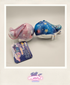Two colorful plush toys with a card on a light gray background
