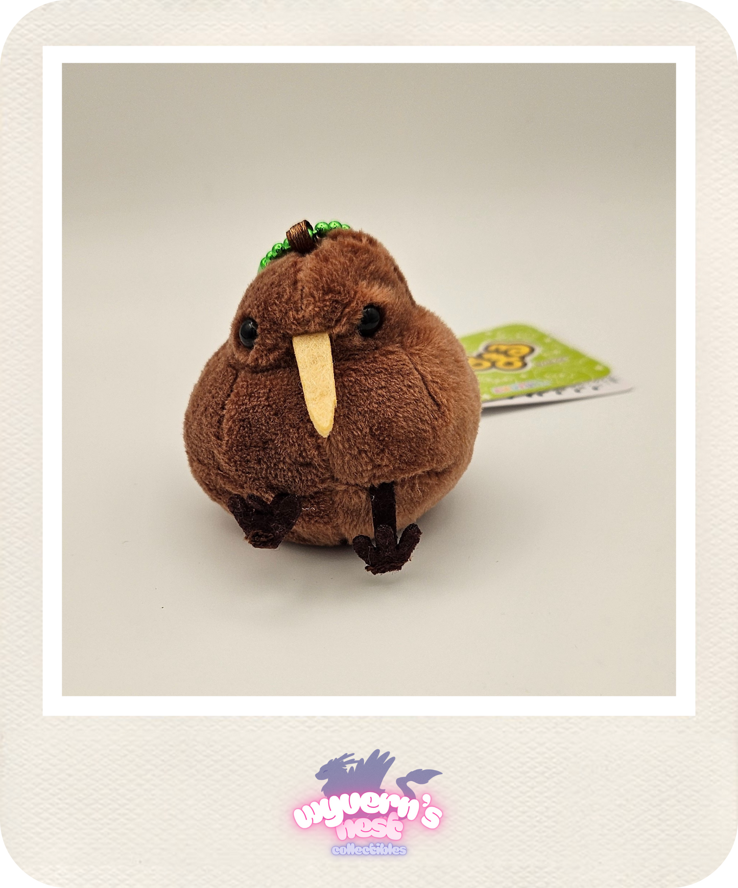 Plush toy resembling a brown bird with a tag in the background