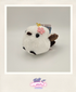 White plush toy bird with a pink flower on a gray background
