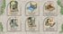 Set of miniature figurines with decorative backgrounds on a textured surface