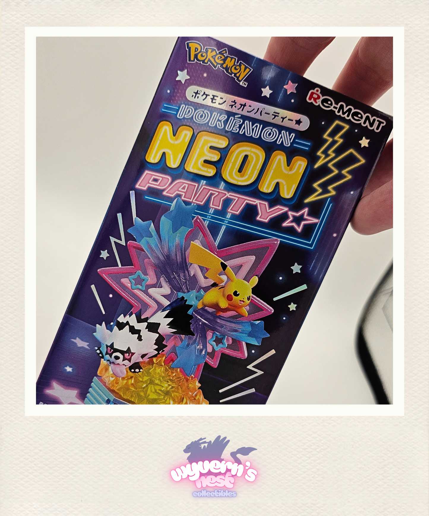 Pokémon IOKEBAION NEON PARTY packaging held by a hand on a light gray background.