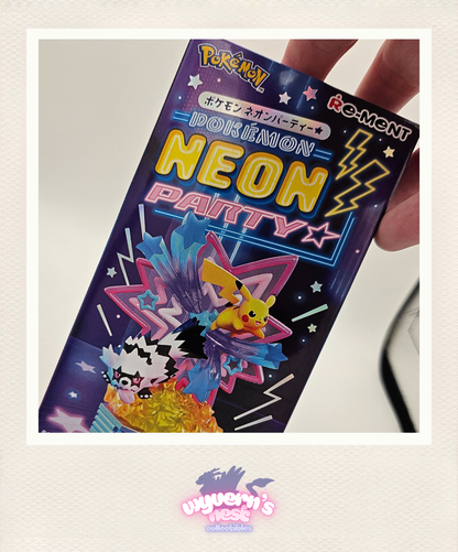 Pokémon IOKEBAION NEON PARTY packaging held by a hand on a light gray background.